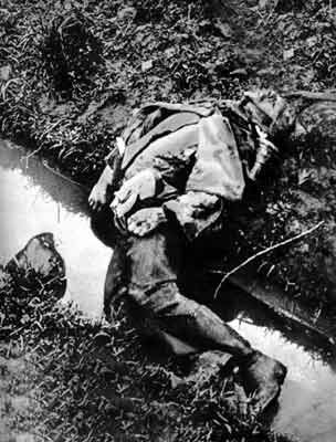 Dead boy soldier in a ditch