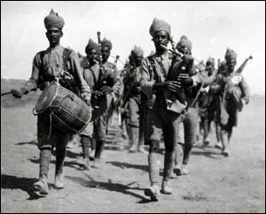 Indian bagpiper marching to the front